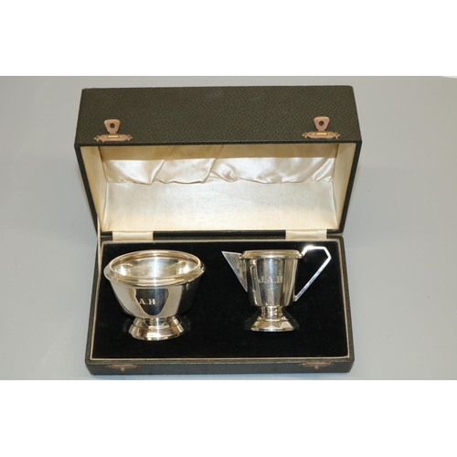 1169 - George V hallmarked silver Art Deco cream jug and sugar bowl, tapering bodies with angular handles o... 