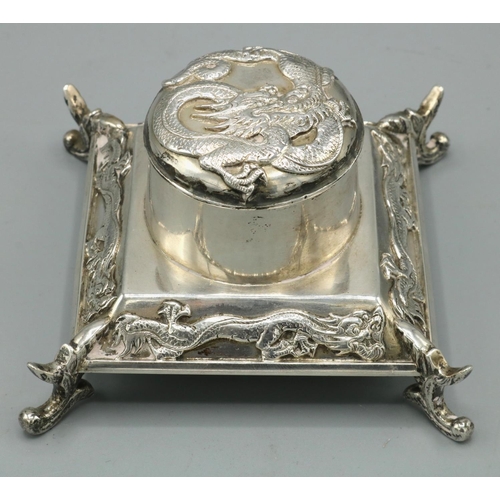 1070 - Early C20th Chinese silver square inkwell, hinged cover and tapering base relief decorated with drag... 