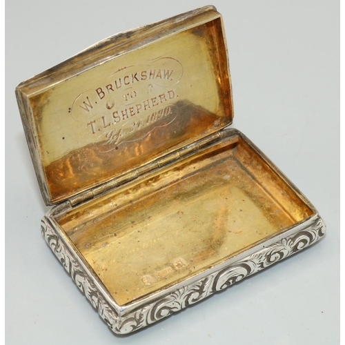 1183 - William IV hallmarked silver rectangular snuff box, repousse and engraved with scrollwork, gilt inte... 