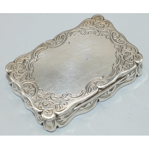 1145 - Victorian hallmarked silver shaped rectangular snuff box, all over engraved with scrolls and vacant ... 