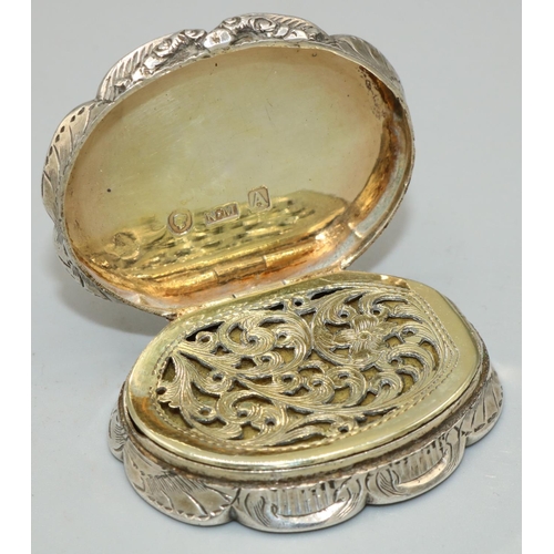 1101 - Victorian hallmarked silver shaped oval vinaigrette, hinged cover with an initialled scroll cartouch... 