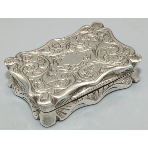 1135 - Victorian hallmarked silver shaped rectangular vinaigrette, all over engraved with scrolls hinged co... 