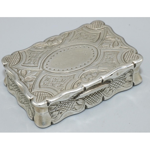 1133 - Victorian hallmarked silver shaped oval vinaigrette, hinged cover with a scroll cartouche on a strap... 