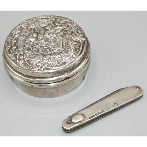 1143 - Late Victorian hallmarked silver circular dressing table jar, twist lock cover repousse with lovers ... 