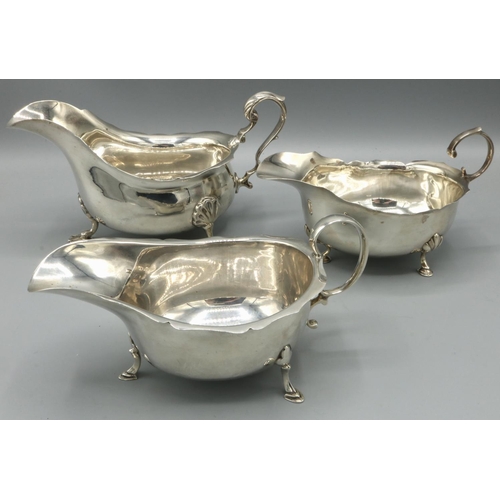 1099 - George V hallmarked silver sauce boat, with shaped rim and  scroll handle on three shell cast feet, ... 