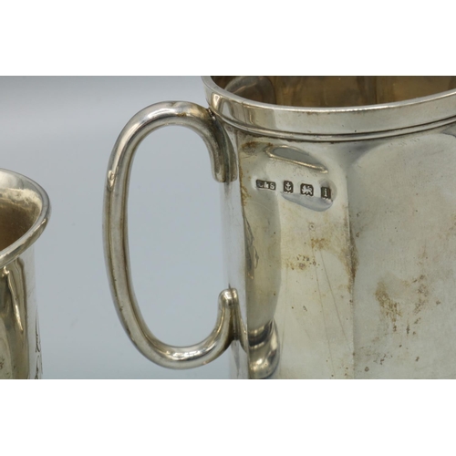 1124 - Edward VII hallmarked silver Christening mug, Sheffield 1904, another Birmingham 1908 and a George V... 