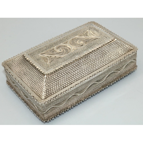 1164 - C20th foreign white metal filigree rectangular box, with stepped hinged lid on four ball feet, L12cm... 