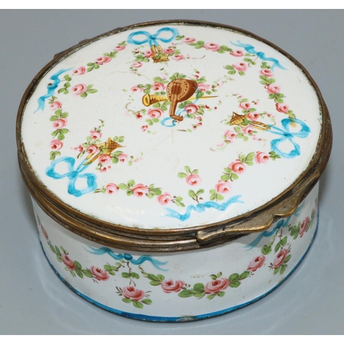 1228 - C19th gilt metal mounted white enamel circular box, painted with musical trophies in ribbon tied flo... 