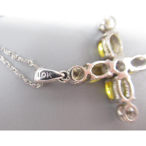 1026 - 10ct white gold crucifix pendant, set with oval cut yellow sapphires and round cut diamonds, on 10ct... 