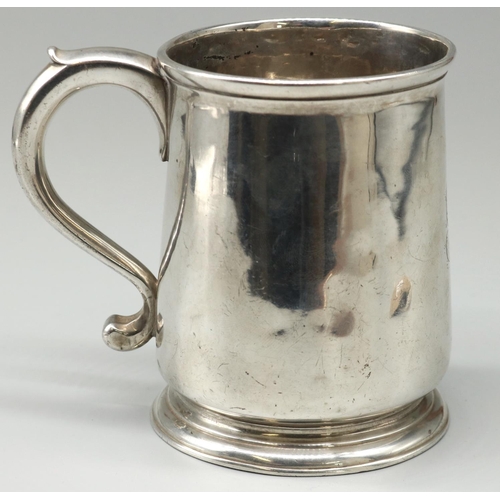 1131 - George III hallmarked silver mug, plain tapering body with S scroll handle, on stepped circular base... 