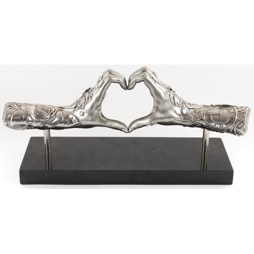 1262 - Dan Lane (British b1980-); 'Gesture of Love', stainless steel sculpture of two arms with tattoos in ... 