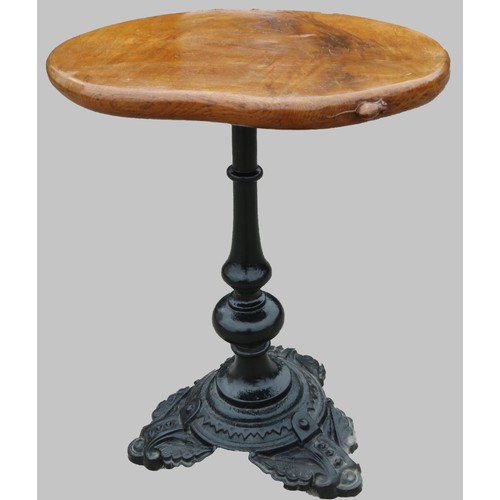 1416 - Robert Mouseman Thompson of Kilburn - a bar table, oval figured oak top on slender cast iron baluste... 