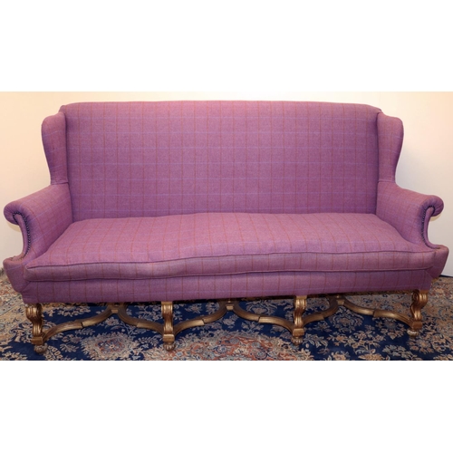 1389 - Queen Anne style sofa with wing back and outsplayed arms, on gilt angular S-scroll legs with bun fee... 