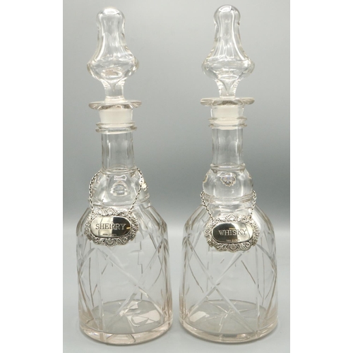 1118 - Pair of Victorian mallet shaped decanters, with facet cut shoulders, ringed neck and faceted stopper... 