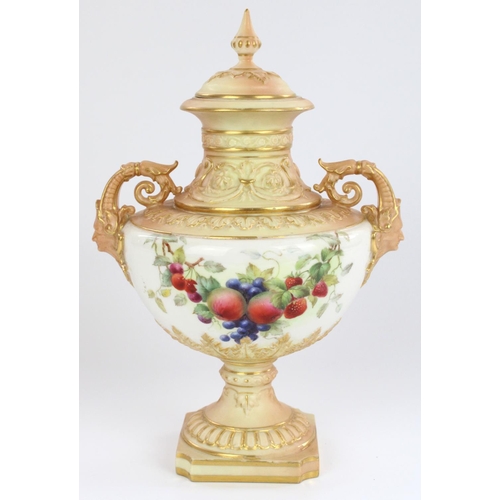 1210 - Royal Worcester twin handled pedestal urn and cover, with mask form scrolling handles and reeded squ... 