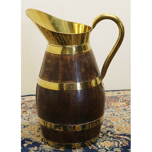 1268 - Large early C20th coopered oak jug, with brass bands, handle and spout, H58cm