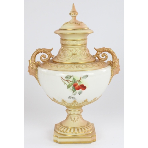 1210 - Royal Worcester twin handled pedestal urn and cover, with mask form scrolling handles and reeded squ... 