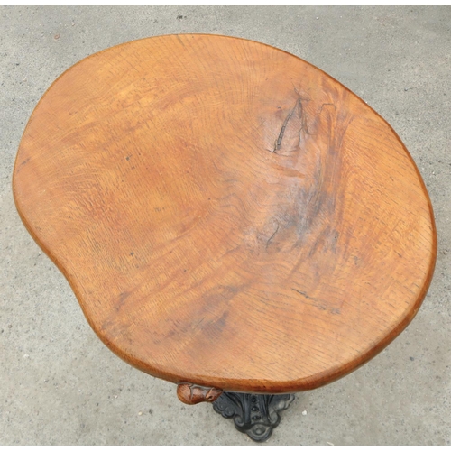 1416 - Robert Mouseman Thompson of Kilburn - a bar table, oval figured oak top on slender cast iron baluste... 