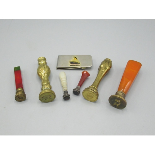 117 - Six brass and other seals and a stainless steel money clip with badge of R.M.S. Titanic (7)