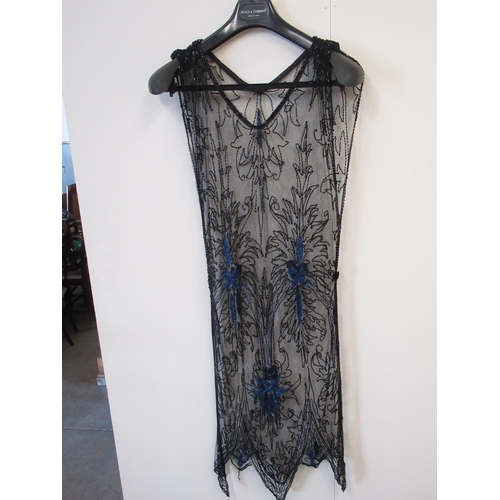 126 - Two 1920s style black sheer dresses, and a collection of 7 faux tortoise shell hair combs