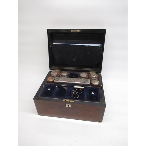 127 - Victorian walnut ladies vanity case, fitted interior with five silver plate topped clear glass bottl... 