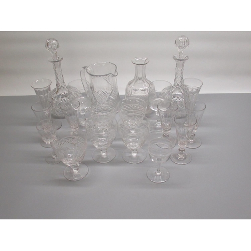 79 - Pair of glass decanters, another decanter (missing stopper), water jug and a collection of glasses (... 