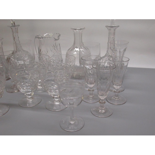 79 - Pair of glass decanters, another decanter (missing stopper), water jug and a collection of glasses (... 