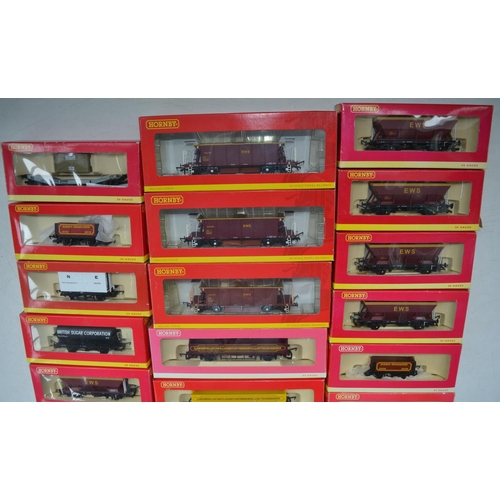 96 - Twenty one OO gauge goods wagons from Hornby to include hoppers, tankers, closed vans, plank wagons,... 