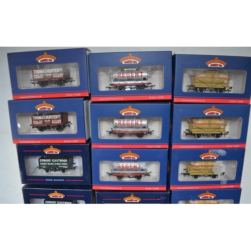 99 - Eighteen Bachmann OO gauge railway wagons to include 7 plank end door wagons, 14 ton tank wagons etc... 