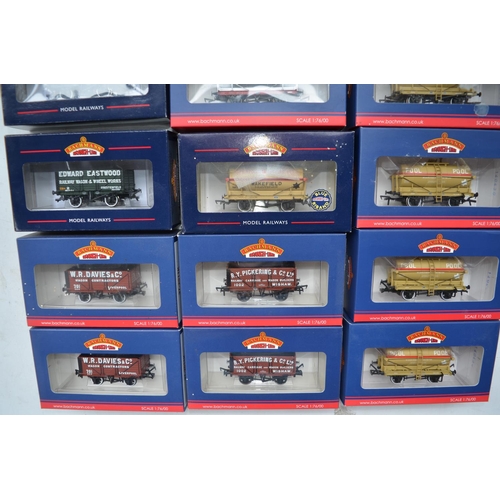 99 - Eighteen Bachmann OO gauge railway wagons to include 7 plank end door wagons, 14 ton tank wagons etc... 