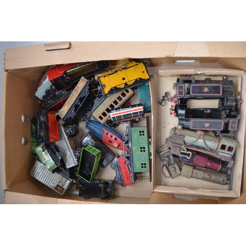 204 - Two boxes of damaged O gauge tin plate model trains and rolling stock including locomotive bodies in... 