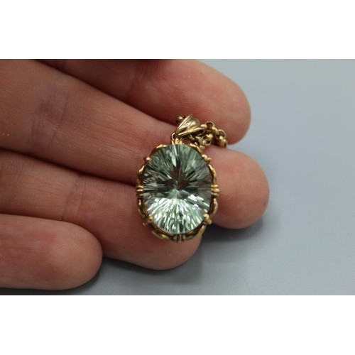 774 - 9ct yellow gold pendant set with oval cut pale green stone in ornate mount, on 9ct yellow gold belch... 