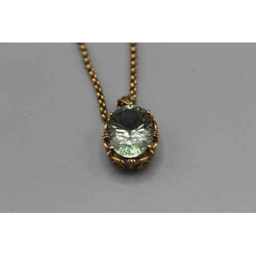 774 - 9ct yellow gold pendant set with oval cut pale green stone in ornate mount, on 9ct yellow gold belch... 