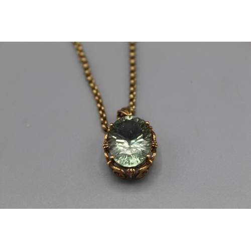 774 - 9ct yellow gold pendant set with oval cut pale green stone in ornate mount, on 9ct yellow gold belch... 