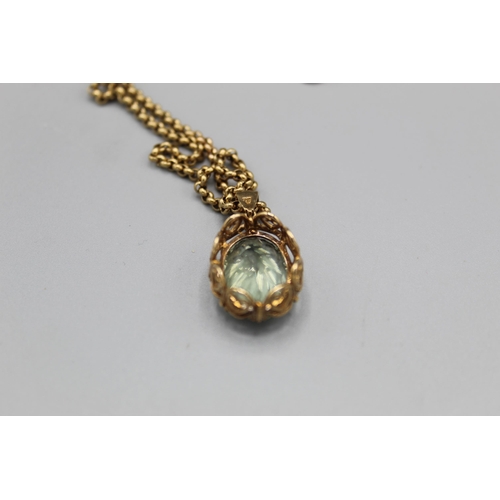 774 - 9ct yellow gold pendant set with oval cut pale green stone in ornate mount, on 9ct yellow gold belch... 