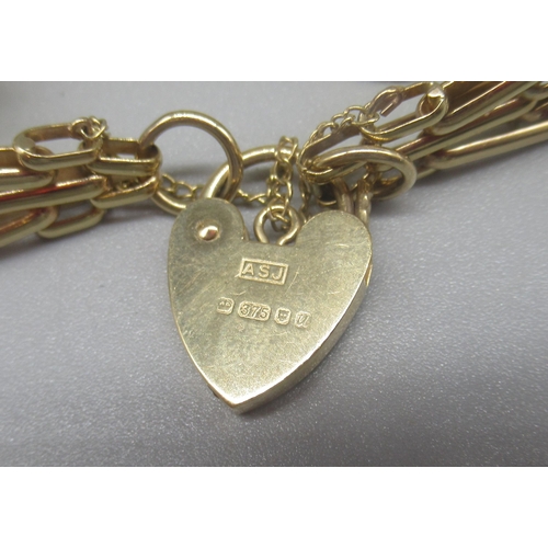 765 - 9ct yellow gold three gate bracelet with heart padlock clasp and safety chain, stamped 375, 18.2g