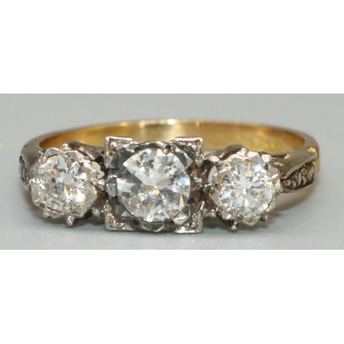 1 - 18ct yellow gold and platinum three stone diamond ring, the central round cut diamond in platinum sq... 
