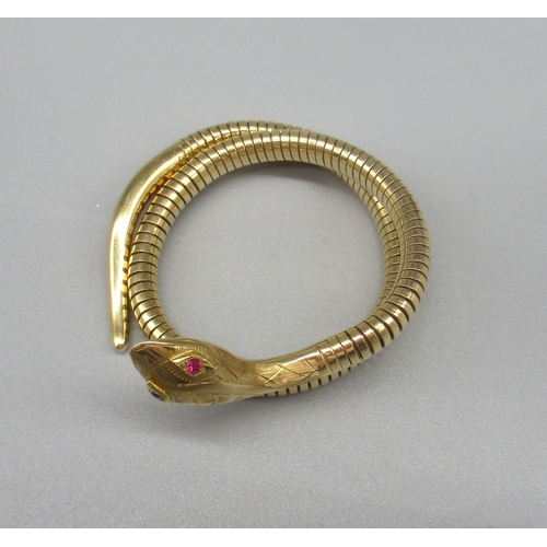 4 - 14ct yellow gold flexible snake bracelet, the head with engraved detail, set with ruby eyes, with fl... 