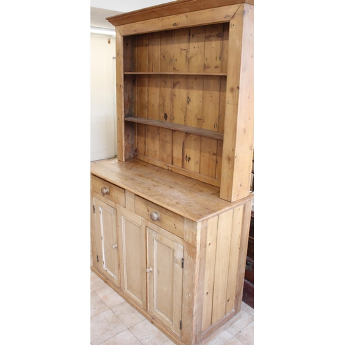 150 - Early C20th pitch pine dresser, two shelf back above two drawers and cupboards on plinth base, H206c... 