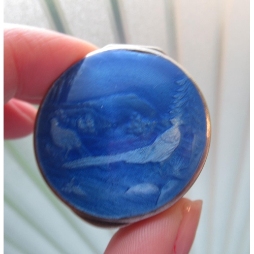 41 - Continental silver pill box with blue enamel lid decorated with exotic birds in landscape, the gilde... 