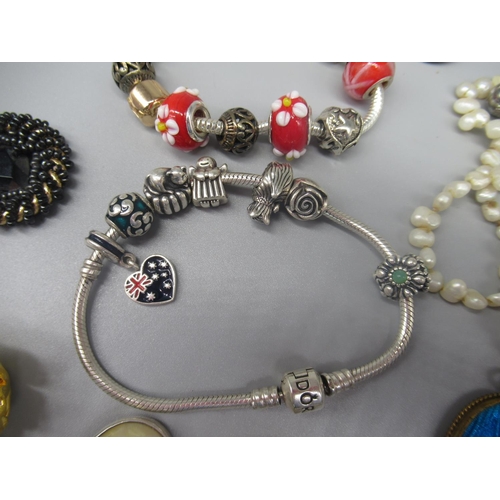 629 - Pandora silver charm bracelet with seven silver charms including a Scottie dog, a rose etc., another... 