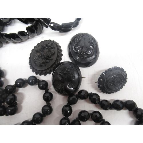 46 - Carved jet cameo brooches, some missing backs, a collection of other jet jewellery and black stone j... 
