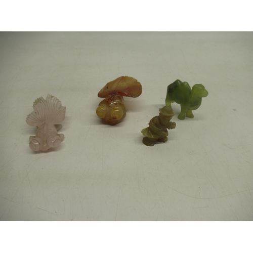 624 - Pink jade carved fish, another similar amber coloured jade fish, a green jade camel and a green jade... 