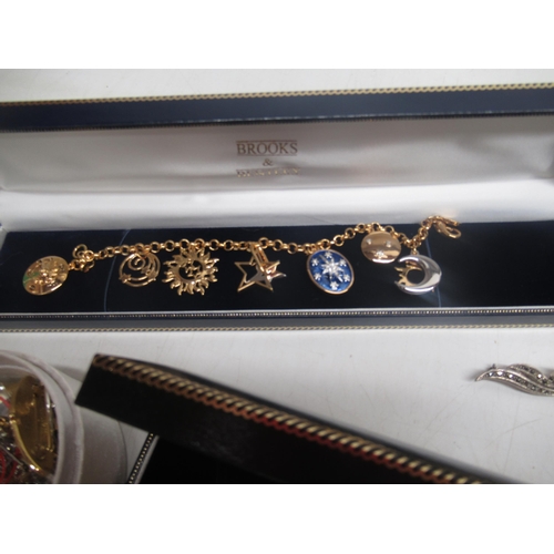 799 - Three Brooks and Bentley yellow metal charm bracelets and a other costume jewellery including brooch... 