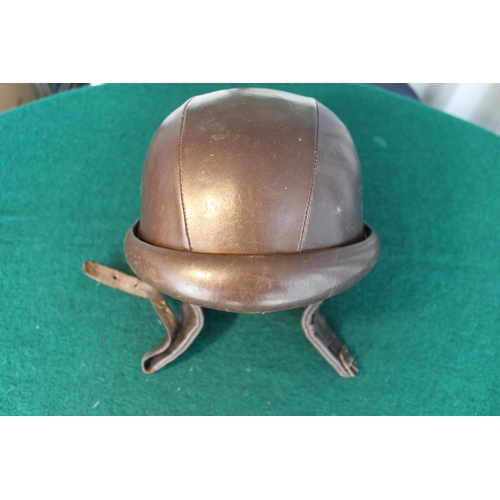 35 - Very early leather racing helmet marked R.M. with a coat of arms depicting a European castle,