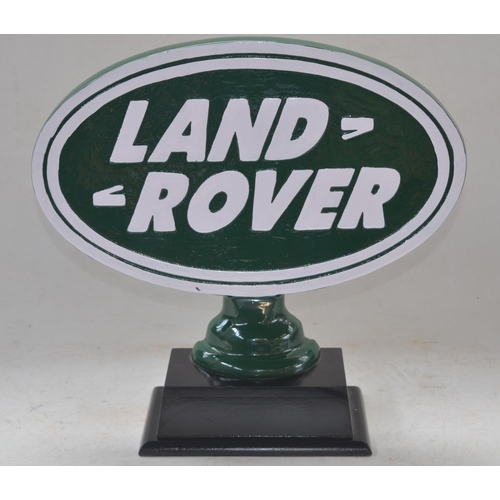 402 - Relief cast metal Land Rover sign on wood base, W40cm D13.5cm H37cm.