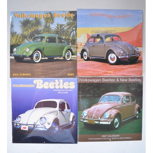 404 - Collection of Volkswagen Beetle ephemera incl. 4 photographic calendars, 3 modern steel plate signs ... 