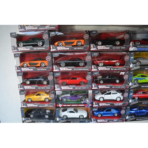 424 - Large collection of boxed diecast Fast & Furious car models by Jada in 1/18th and 1/24th scales. Als... 