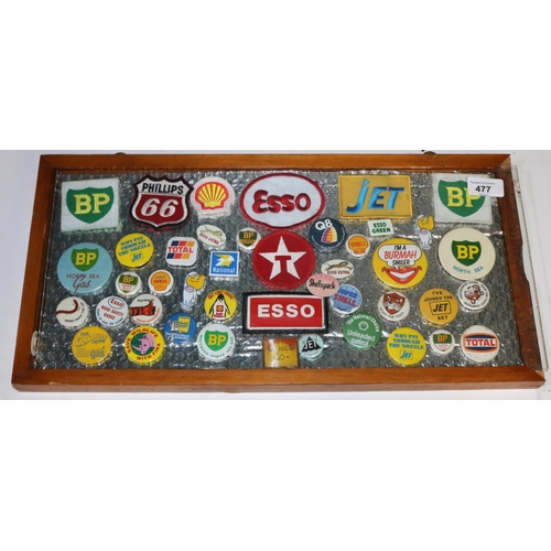 477 - Framed collection of oil and petrol company pin badges and patches, Phillips, BP, Jet, Shell etc, ap... 