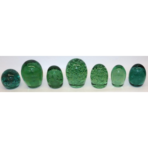 417 - Group of seven green glass dumps, four with internal flowers, max H13cm.